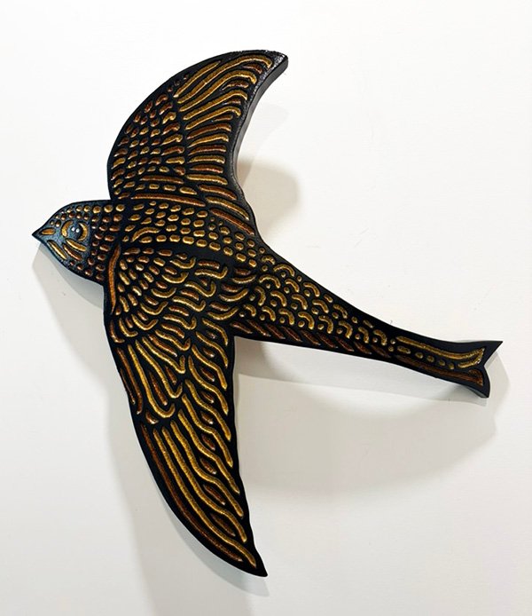 wood carving on curved oak of a Swift bird in flight by Canadian artist Lisa Brawn